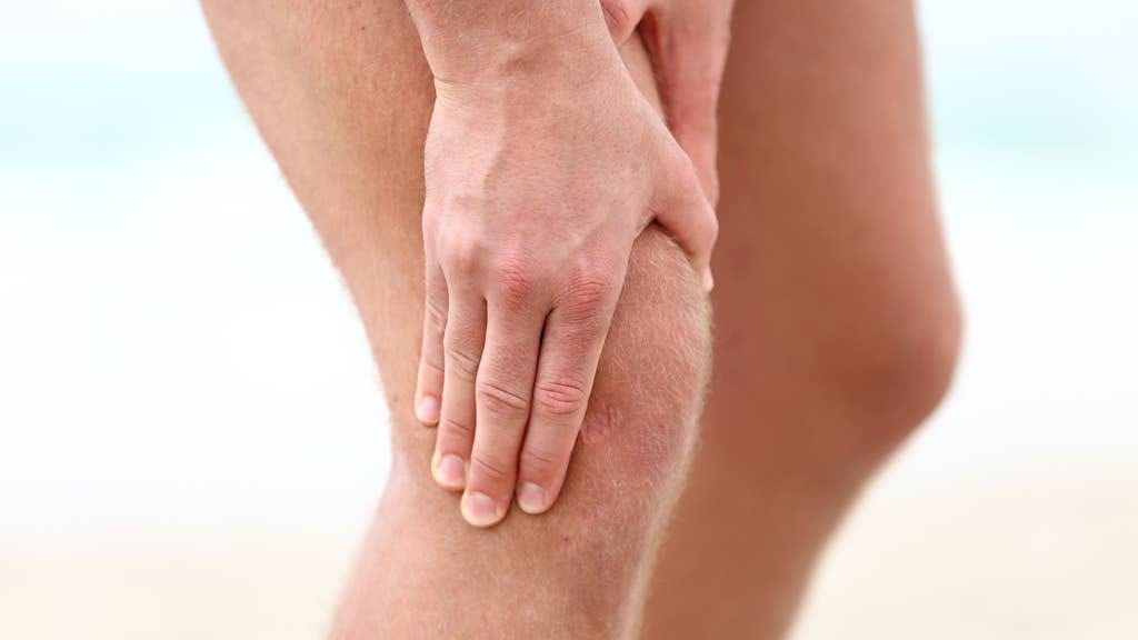 A man holding his knee joints