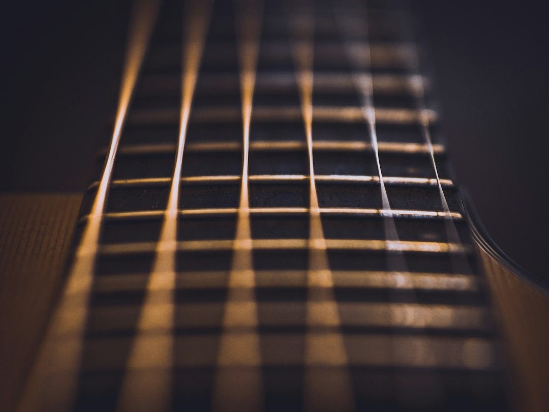 close-up photo of guitar strings close-up photo of guitar strings