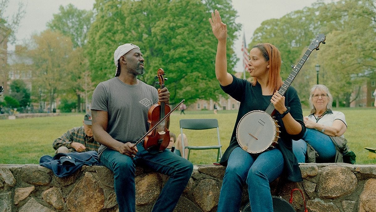 Rhiannon Giddens and Justin Robinson play instruments outside Wilson Library Rhiannon Giddens and Justin Robinson play instruments outside Wilson Library