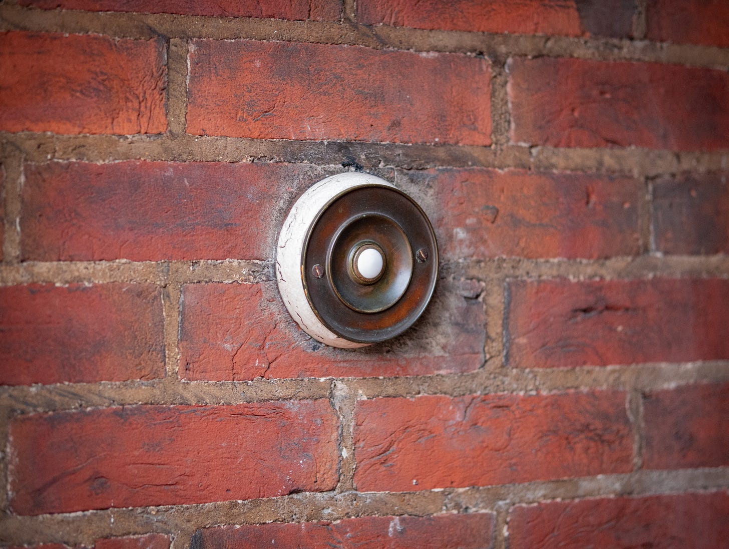 A photo of a doorbell on a brick wall A photo of a doorbell on a brick wall