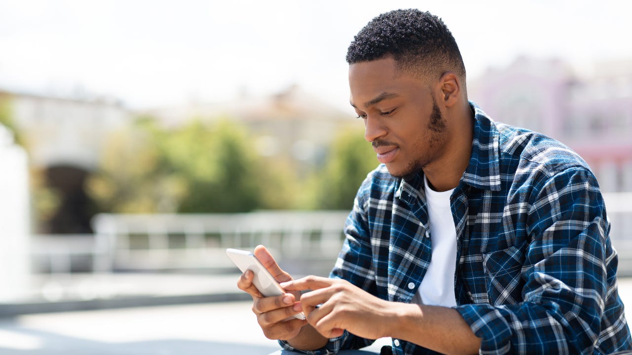 A man reading something on his smartphone.