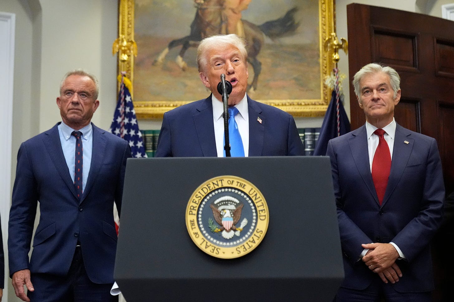 President Trump speaks at a White House podium flanked by Robert F. Kennedy Jr. and Dr. Mehmet Oz President Trump speaks at a White House podium flanked by Robert F. Kennedy Jr. and Dr. Mehmet Oz