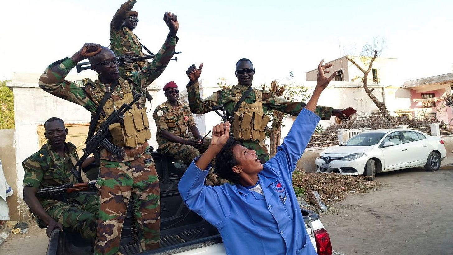 Sudanese citizens celebrate in Port Sudan, Sudan, following an announcement by the army that it had taken the city of Wad Madani, on January 11.