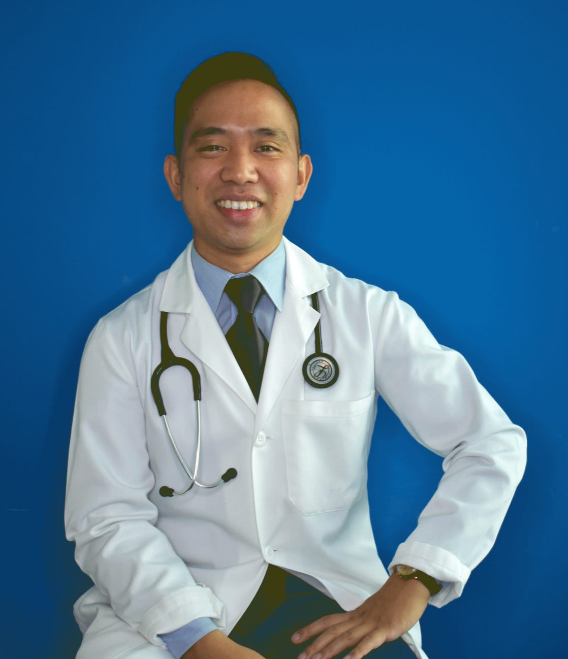 Photograph of a physician against blue background.