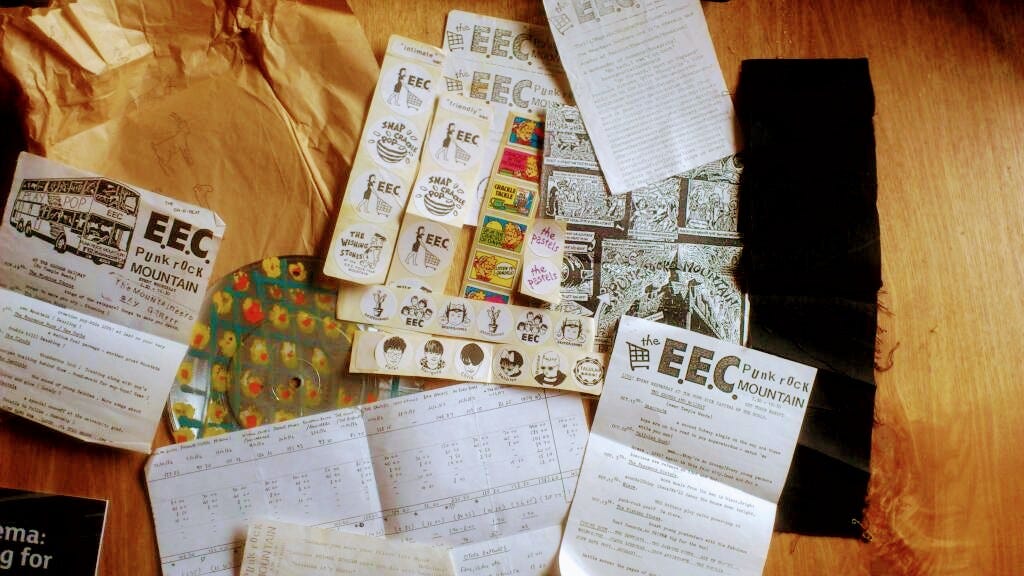 Various free gifts, stickers, handouts and a photocopy of a spreadsheet of accounts