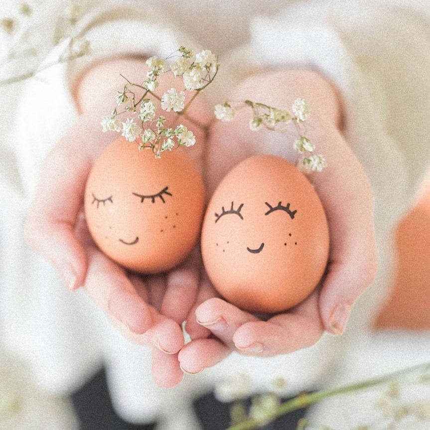 woman in white wedding dress holding two brown eggs