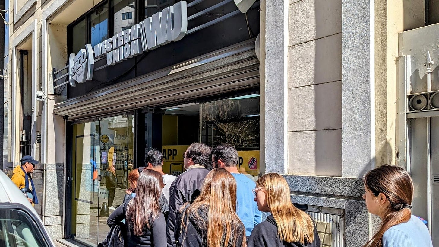 A group of people standing outside a building

Description automatically generated