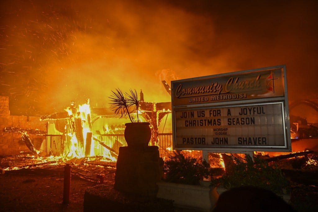 House engulfed in flames during a wildfire in Pacific Palisades, California, with residents fleeing the scene on January 8, 2025.