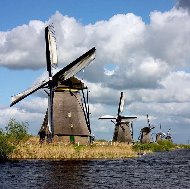 LEFT: The Mill (1648) by Rembrandt. RIGHT: A photograph of the windmills at Kinderdijk, Netherlands.