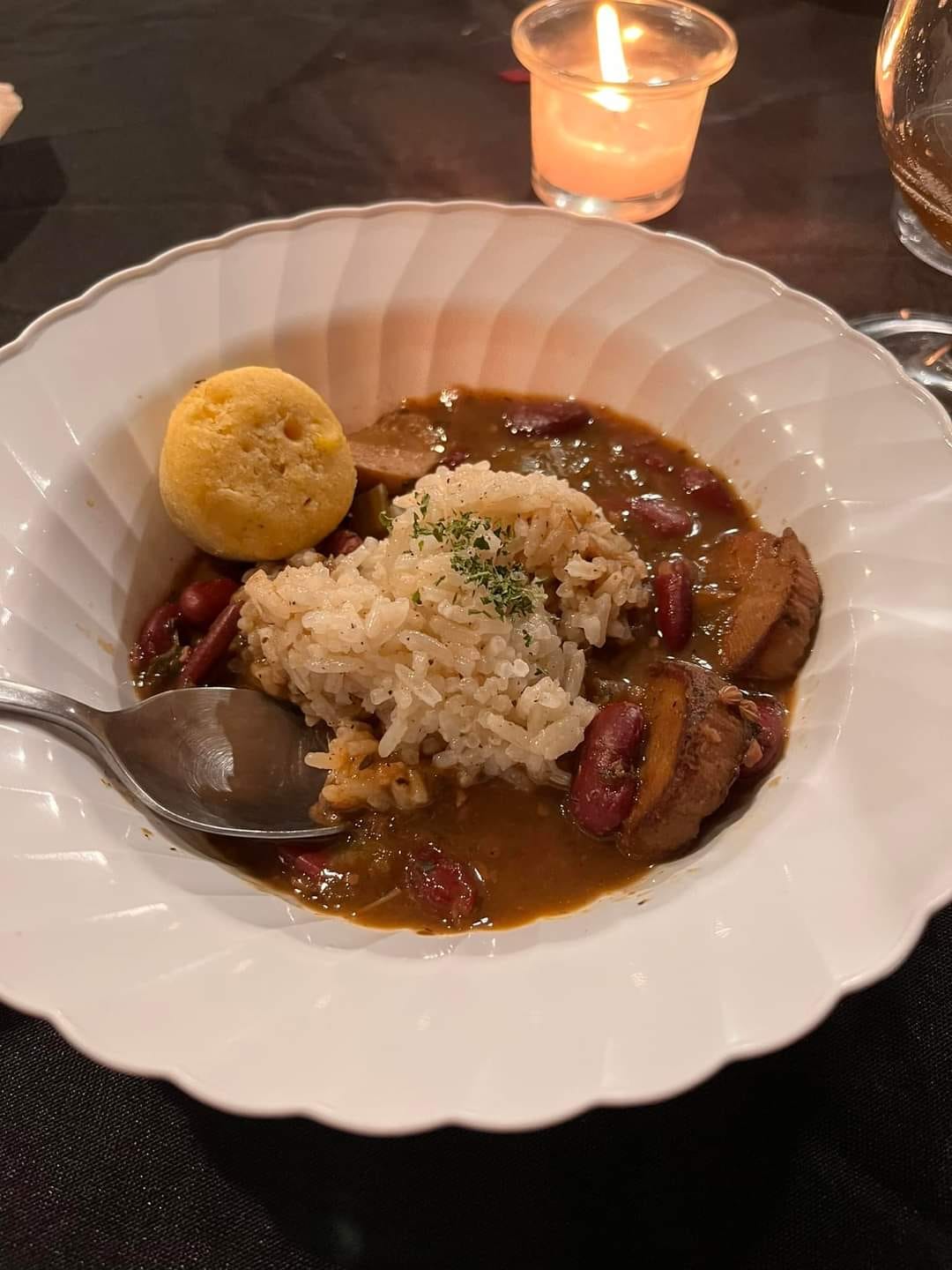 A delicious bowl of stew with chunks of veggies and rice rests on a table, inviting you to dig in.