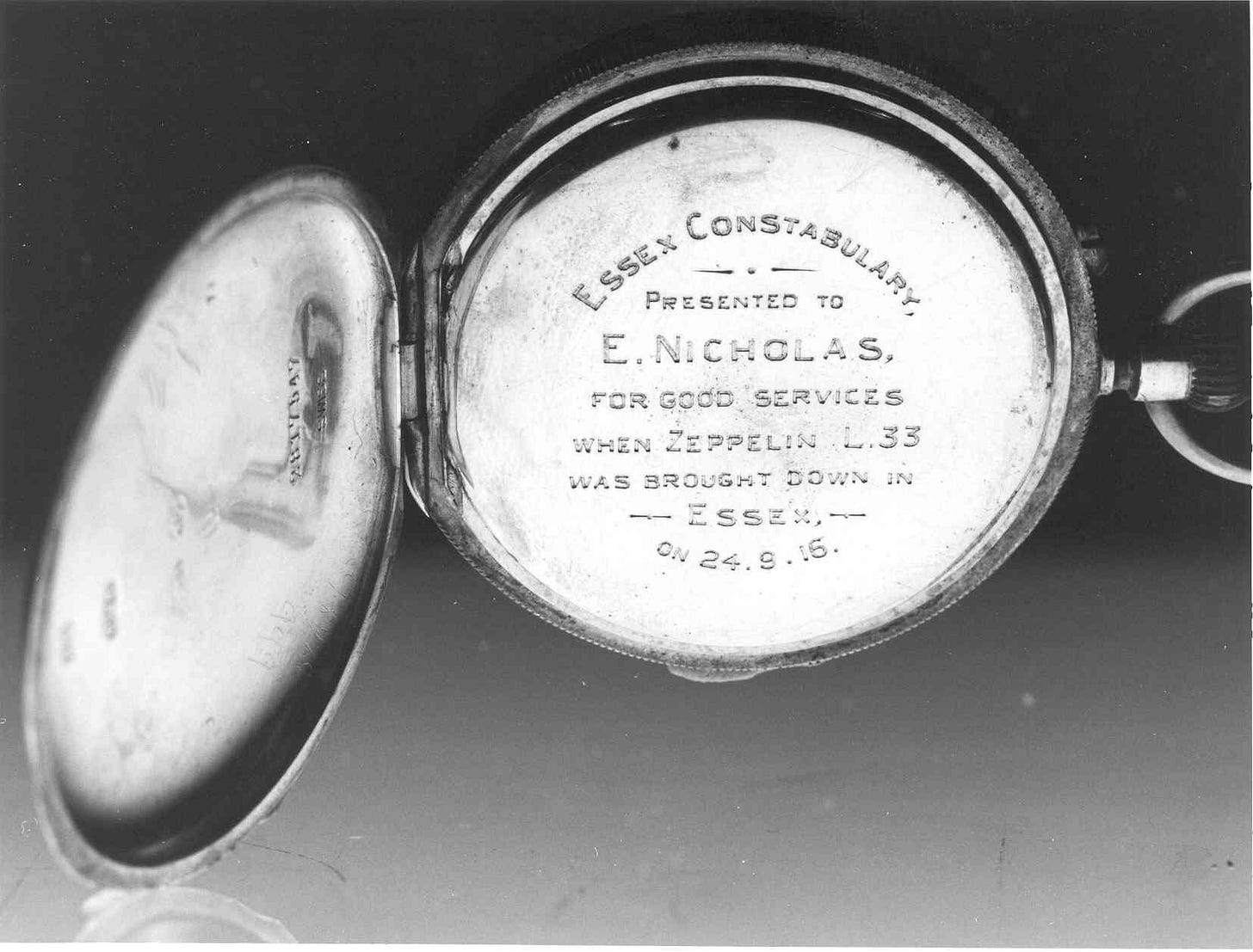 A close up photo of the open pocket watch, showing the inscription.