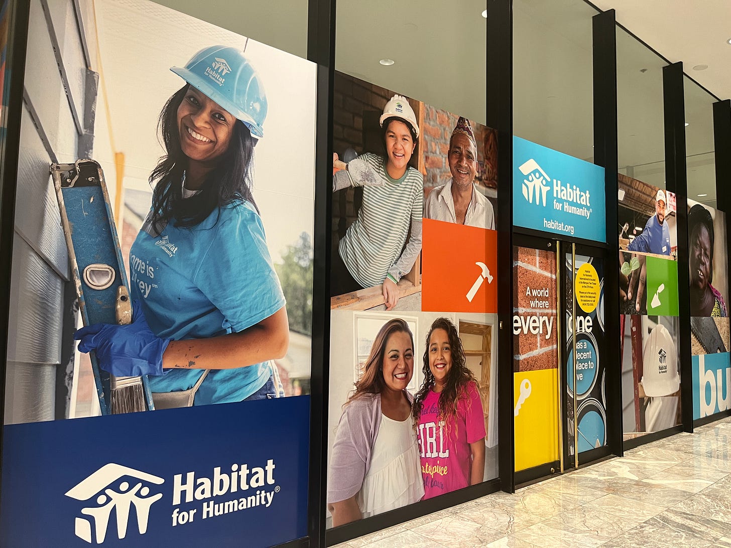 A full wall photo collage outside of Habitat for Humanity International's Headquarters.