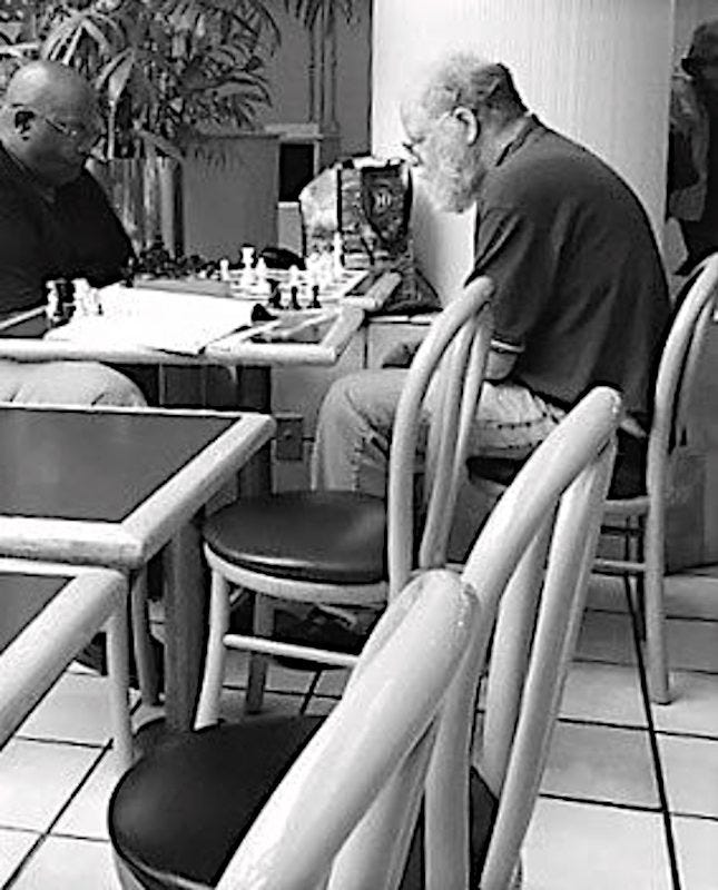 May be a black-and-white image of 2 people and chess