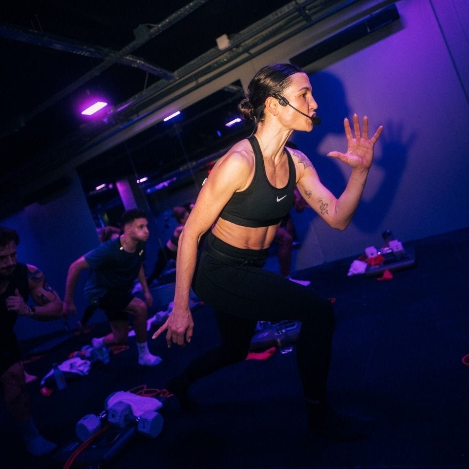 Fitness instructor leading a workout class at Episod in Paris Fitness instructor leading a workout class at Episod in Paris