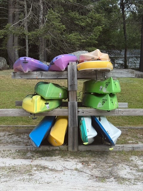 Brightly colored kayaks lined up by the water, inspiring summer outdoor vibes and adventure.  Sometimes fashion inspiration is in our surroundings!