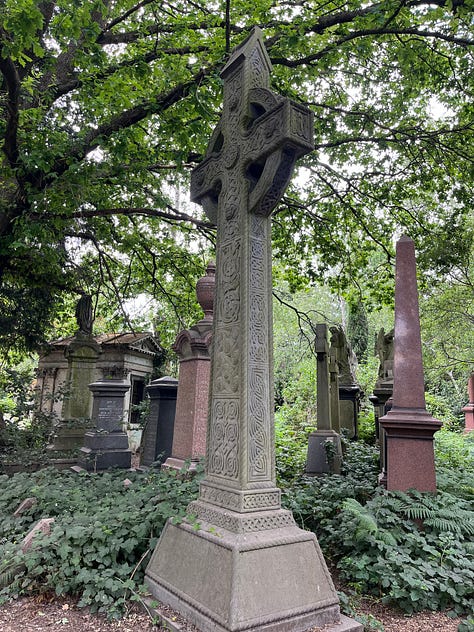 Several Victorian Celtic cross grave monuments in an overgrown cemetery