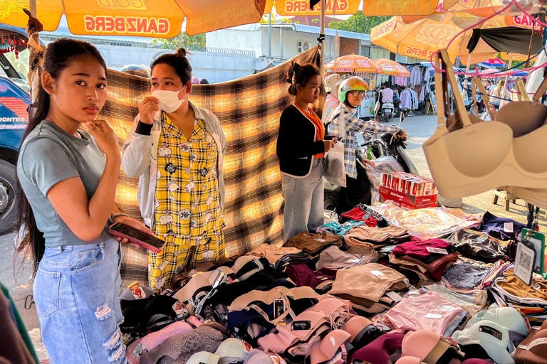 People shop for clothes at a market, after U.S. President Donald Trump announced a 90-day pause on tariffs for many countries, in Phnom Penh, Cambodia, April 9, 2025.