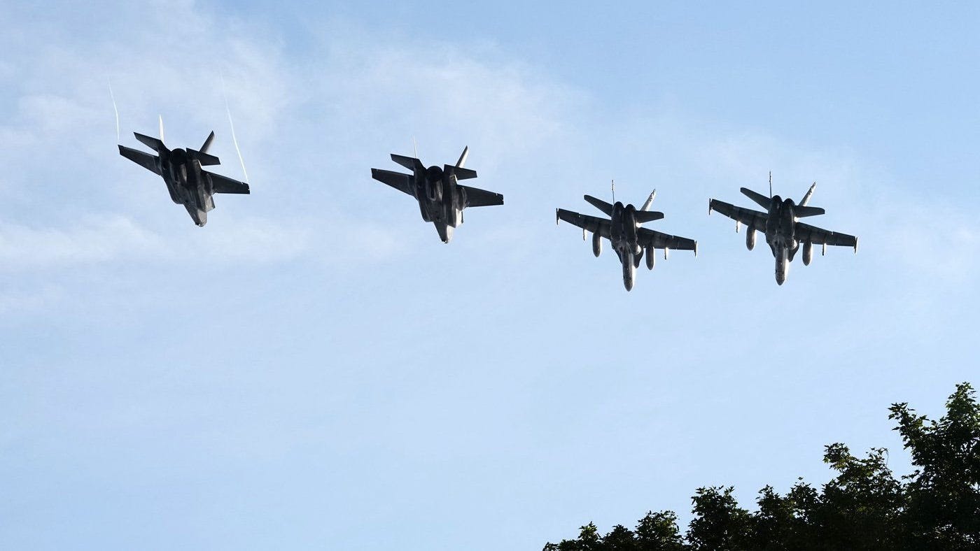 A group of fighter jets flying in the sky

AI-generated content may be incorrect.
