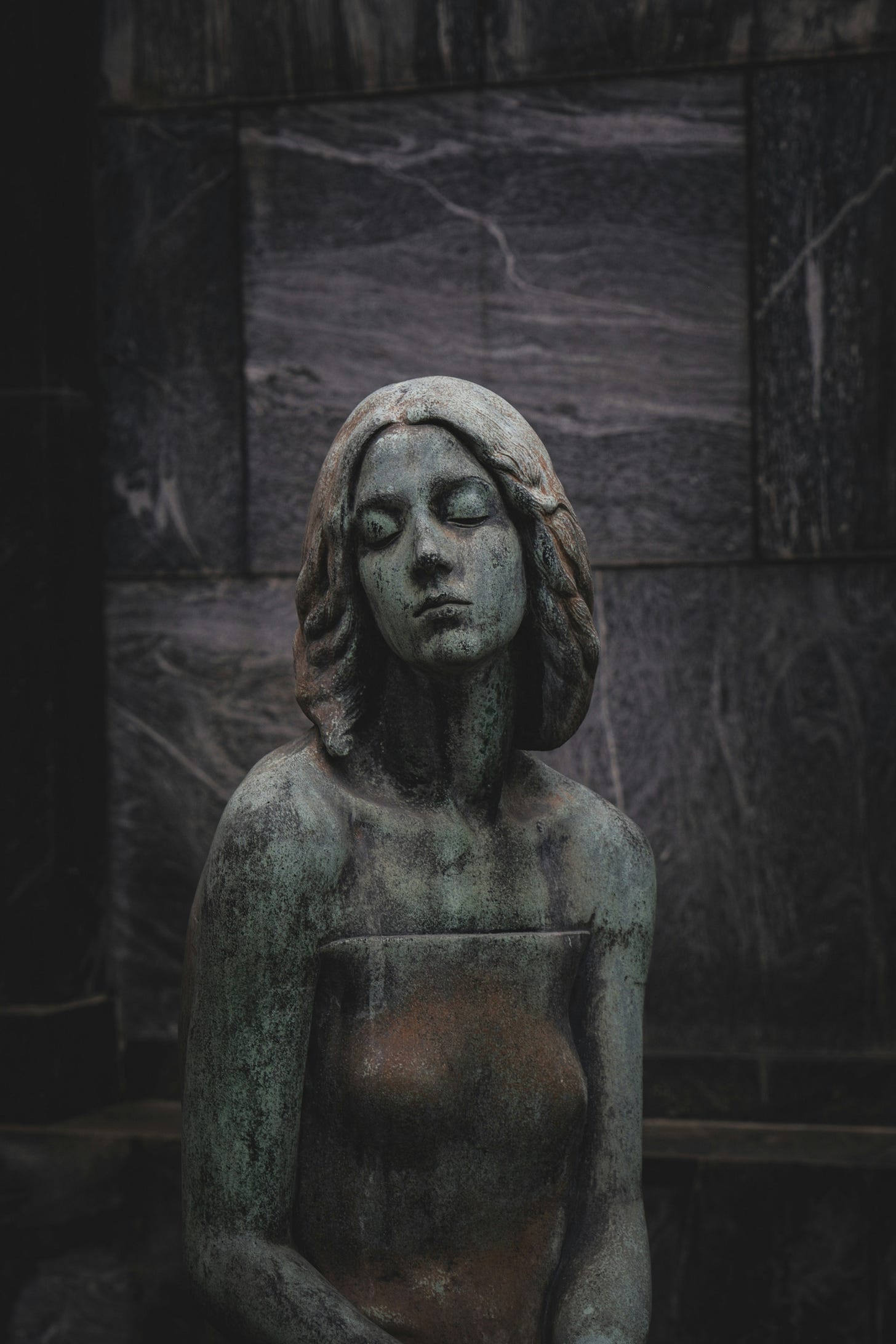 statue of a woman sitting with her eyes closed
