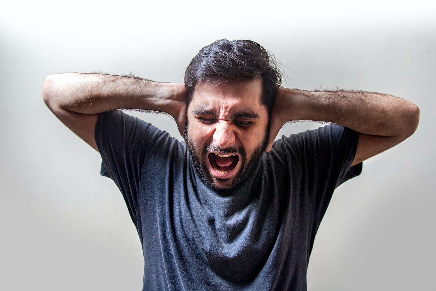 Frustrated Young Man Screaming in Fear Frustrated Young Man Screaming in Fear