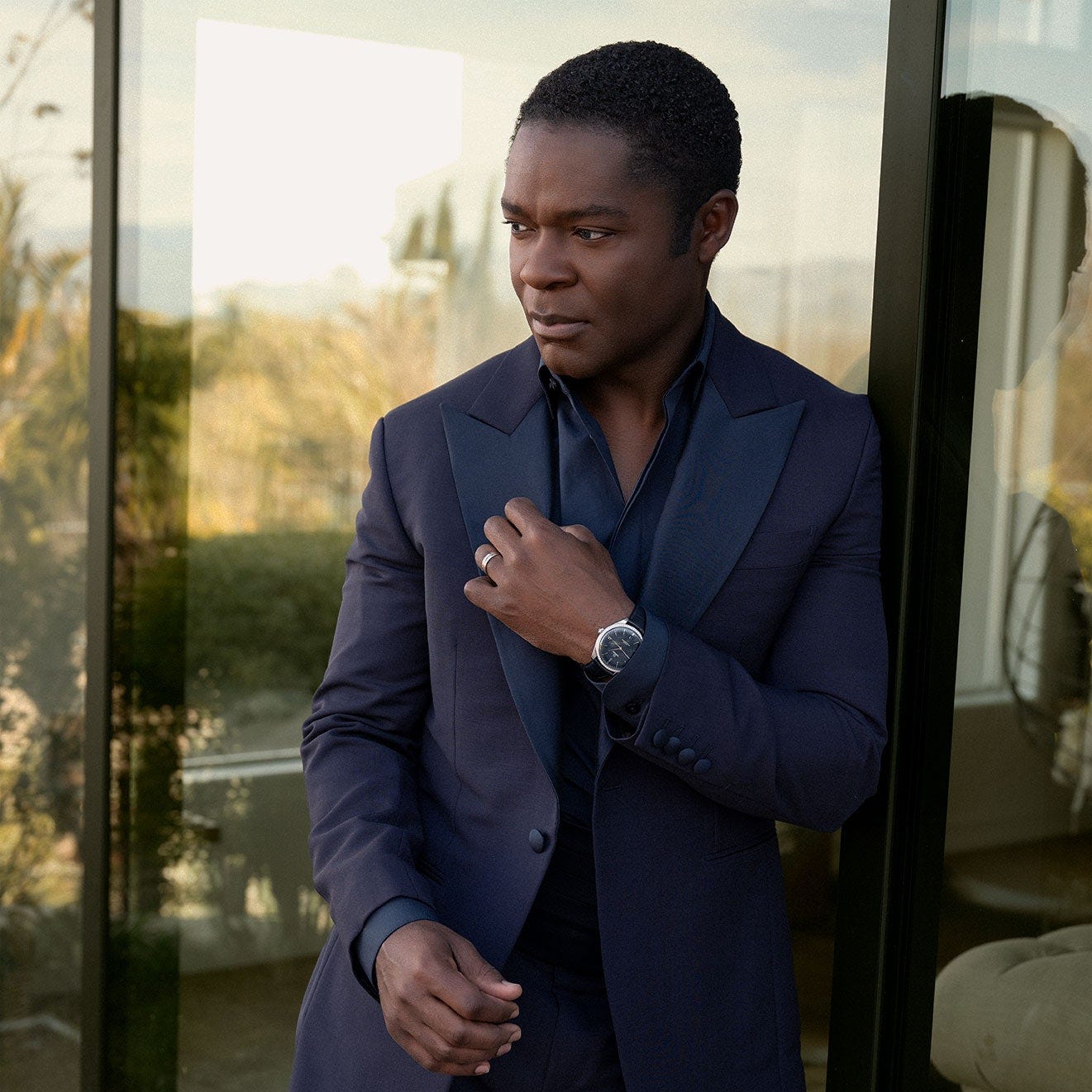 Image may contain David Oyelowo Clothing Formal Wear Suit Blazer Coat Jacket Adult Person Wristwatch and Head