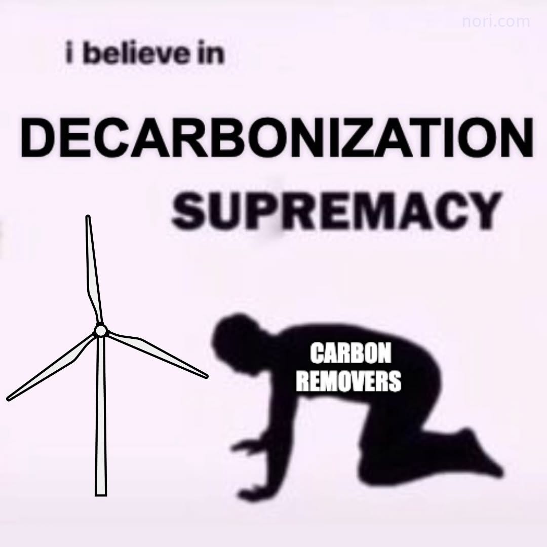 A wind turbine beside a kneeling silhouette labelled "carbon removers", under the text "i believe in DECARBONIZATION SUPREMACY".