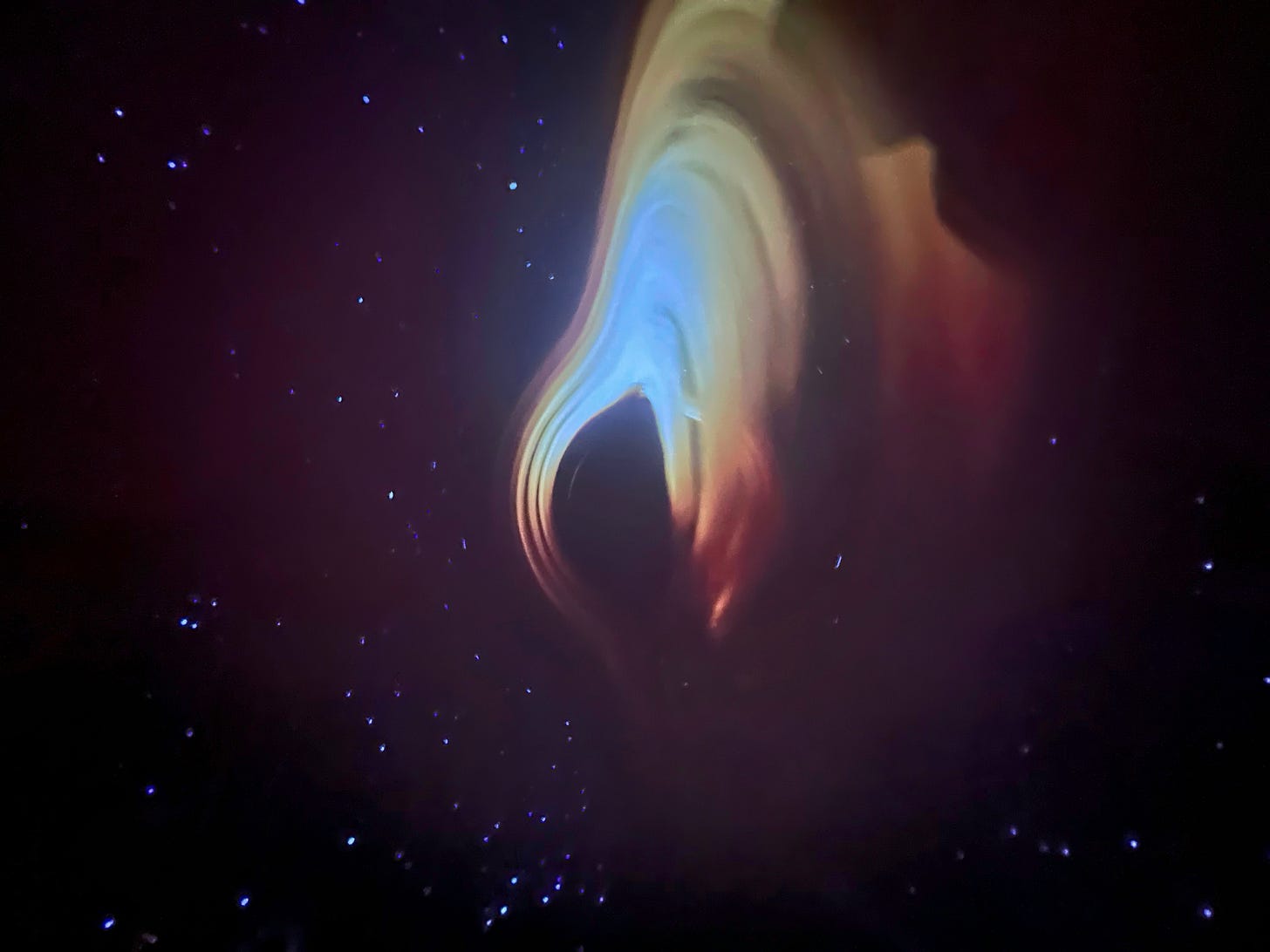 A photograph of the pre-show at the Burke Baker Planetarium at the Houston Museum of Natural Science with stars, black holes, and nebulae in swirling colors