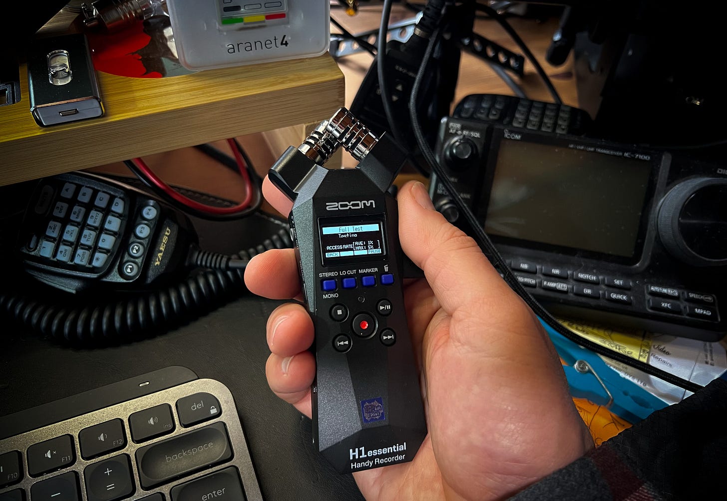 An image of the Zoom H1e being held above my desk while it performs a full test on a new SD card