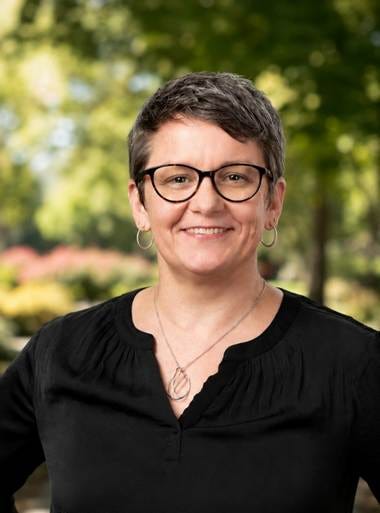 Image of Andrea Rutherford, Founder of Vision to Transition. Andrea has short dark hair and glasses. She is wearing a black blouse with a nature setting behind her. Image of Andrea Rutherford, Founder of Vision to Transition. Andrea has short dark hair and glasses. She is wearing a black blouse with a nature setting behind her.