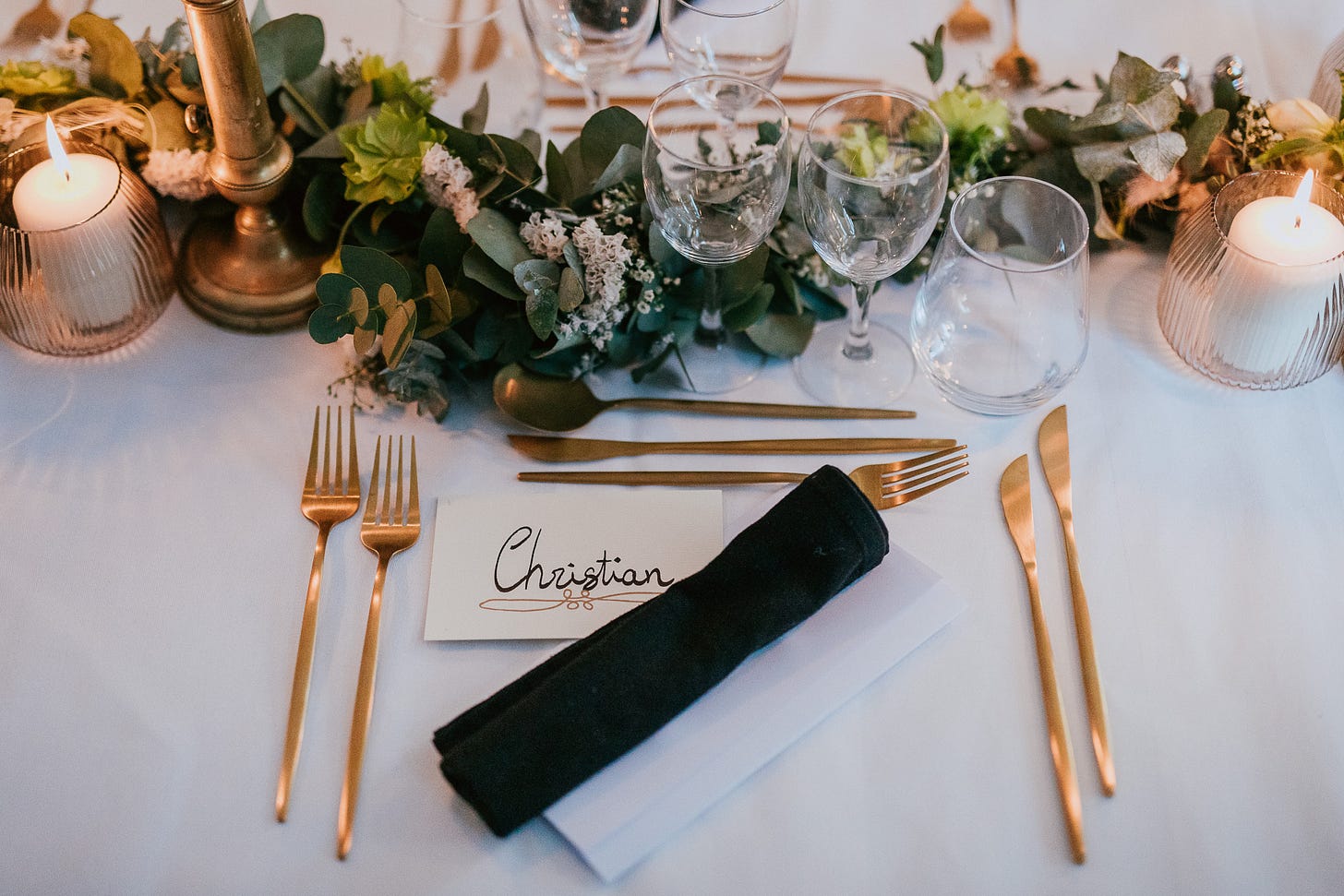 Silverware, candles and flowers on a wedding dinner table Silverware, candles and flowers on a wedding dinner table