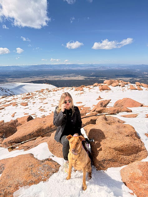 A photo gallery featuring moments from daily life and wellness: a charcuterie board, a cozy dog lounging on a bed, snowy mountain scenes, skiing, smiling couple, a local Boulder shop sign, spring flowers, a knit project, and a scenic desert hike.” This keeps it keyword-relevant (wellness, nature, lifestyle, Boulder, cozy, daily moments) and descriptive enough for accessibility.
