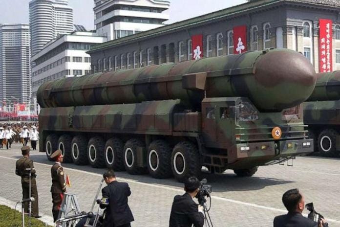 A military vehicle with a missile on the side

Description automatically generated