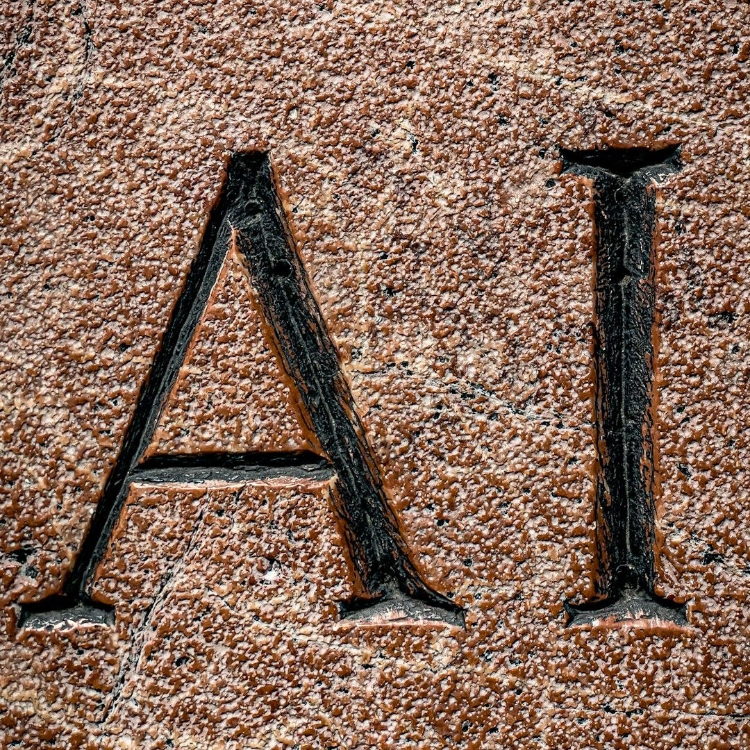The letters "ai" are carved into a stone. The letters "ai" are carved into a stone.