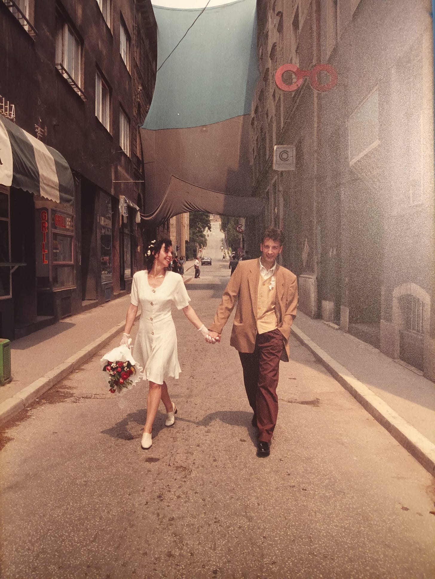 May be an image of 2 people, suit, wedding and street