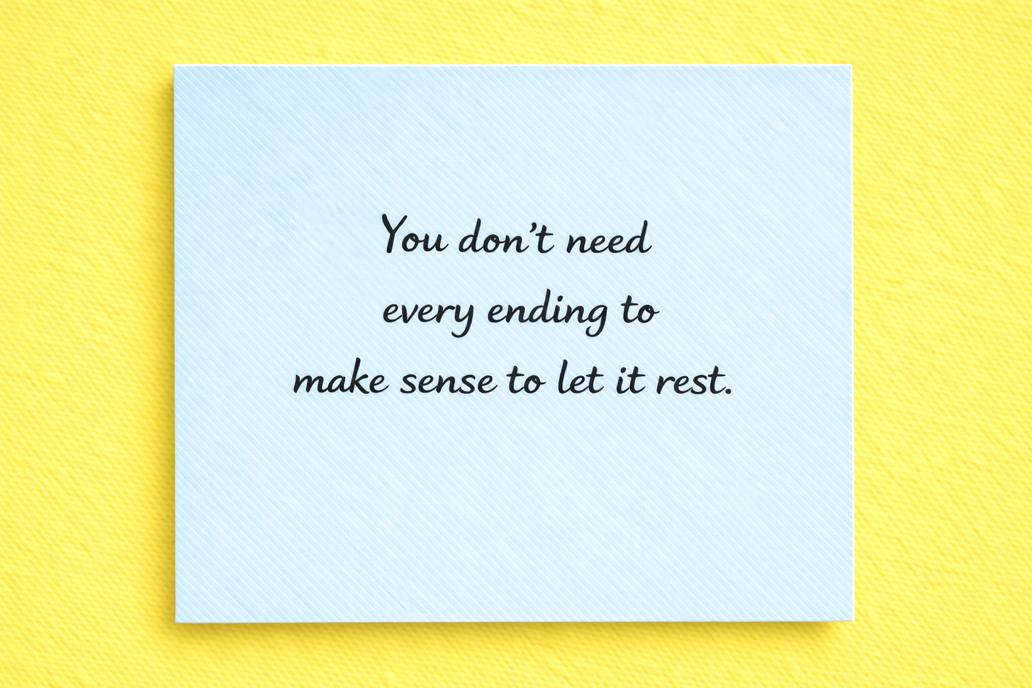 Blue sticky note on a yellow background reading: “You don’t need every ending to make sense to let it rest.”
