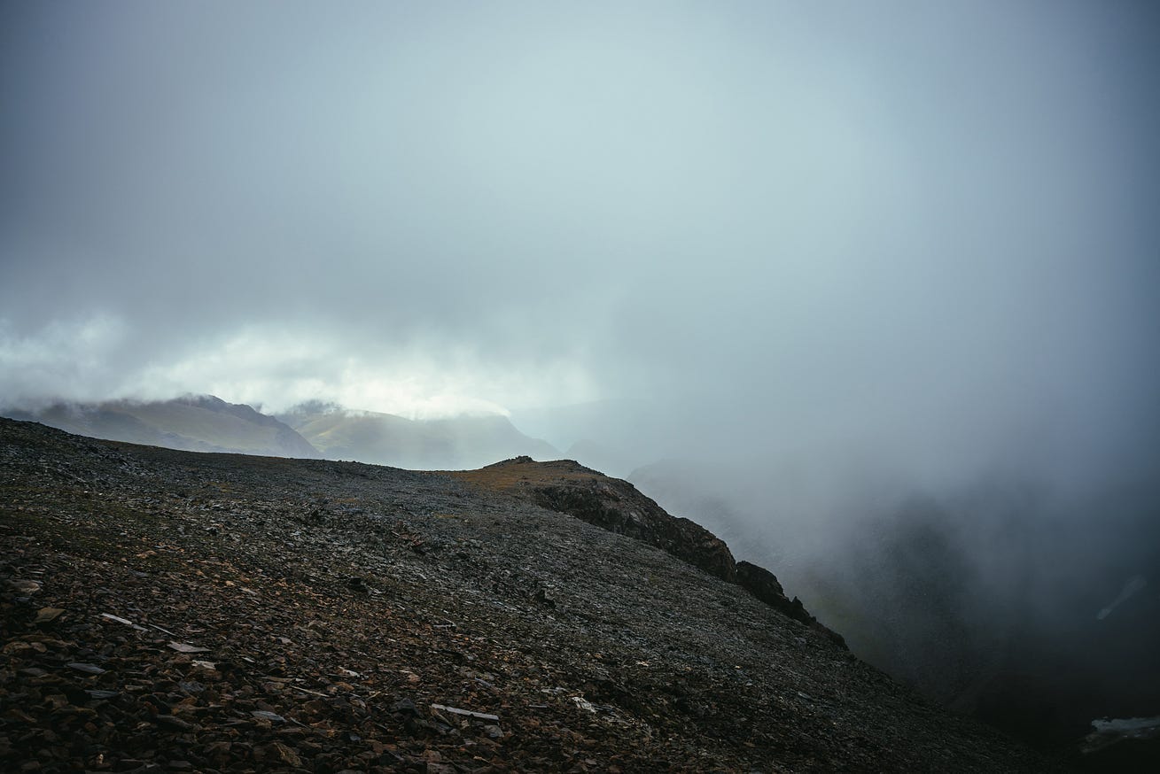 Dark atmospheric landscape on edge of abyss in highlands. Dangerous mountains and abyss among low clouds. Danger mountain pass and sharp rocks in clouds. Dangerous cloudy rainy weather in mountains. See Less By Daniil Dark atmospheric landscape on edge of abyss in highlands. Dangerous mountains and abyss among low clouds. Danger mountain pass and sharp rocks in clouds. Dangerous cloudy rainy weather in mountains. See Less By Daniil