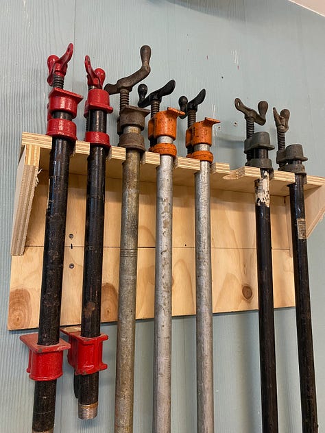 Wall-mounted clamp racks.
