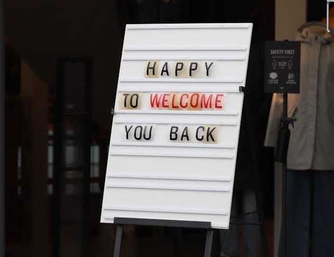 a sign that says happy to welcome you back a sign that says happy to welcome you back