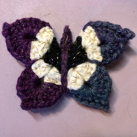 Nine multi-coloured crocheted butterflies