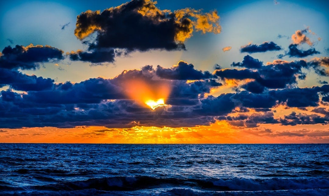 body of water during sunset