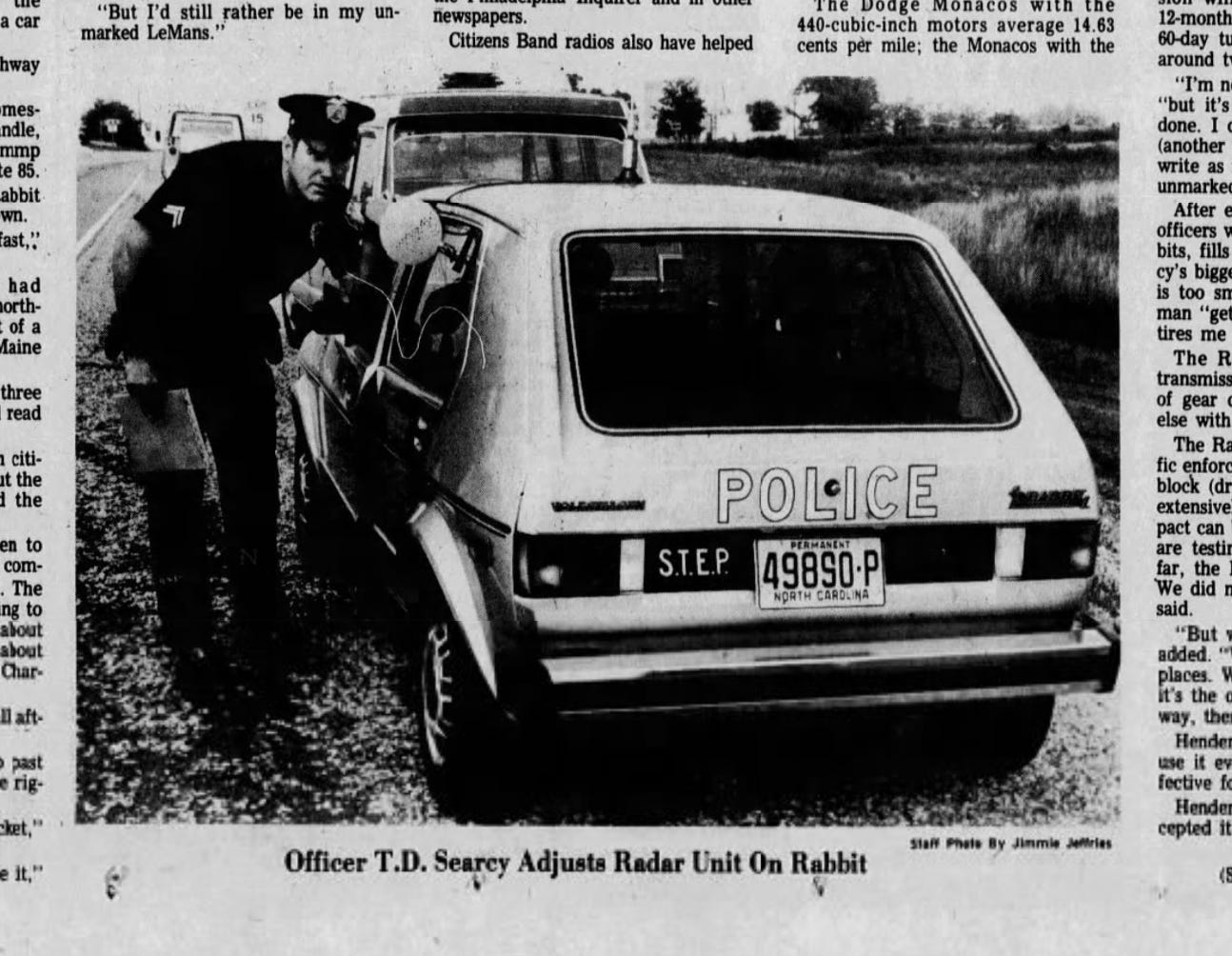 "Officer TD Searcy adjusts radar on Rabbit" along with image of officer next to car from newspaper "Officer TD Searcy adjusts radar on Rabbit" along with image of officer next to car from newspaper