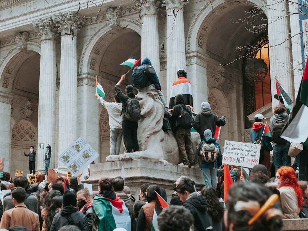 a crowd of people standing in front of a building a crowd of people standing in front of a building