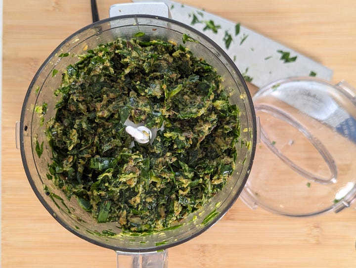Gallery showing two images: ingredients for collard greens gyoza filling laid out on a cutting board, and the finished filling blended in a food processor bowl.
