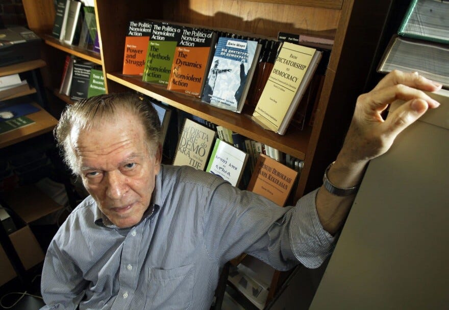 Gene Sharp poses at his office in Boston Thursday, June 25, 2009 with some of his books. (Elise Amendola/AP)