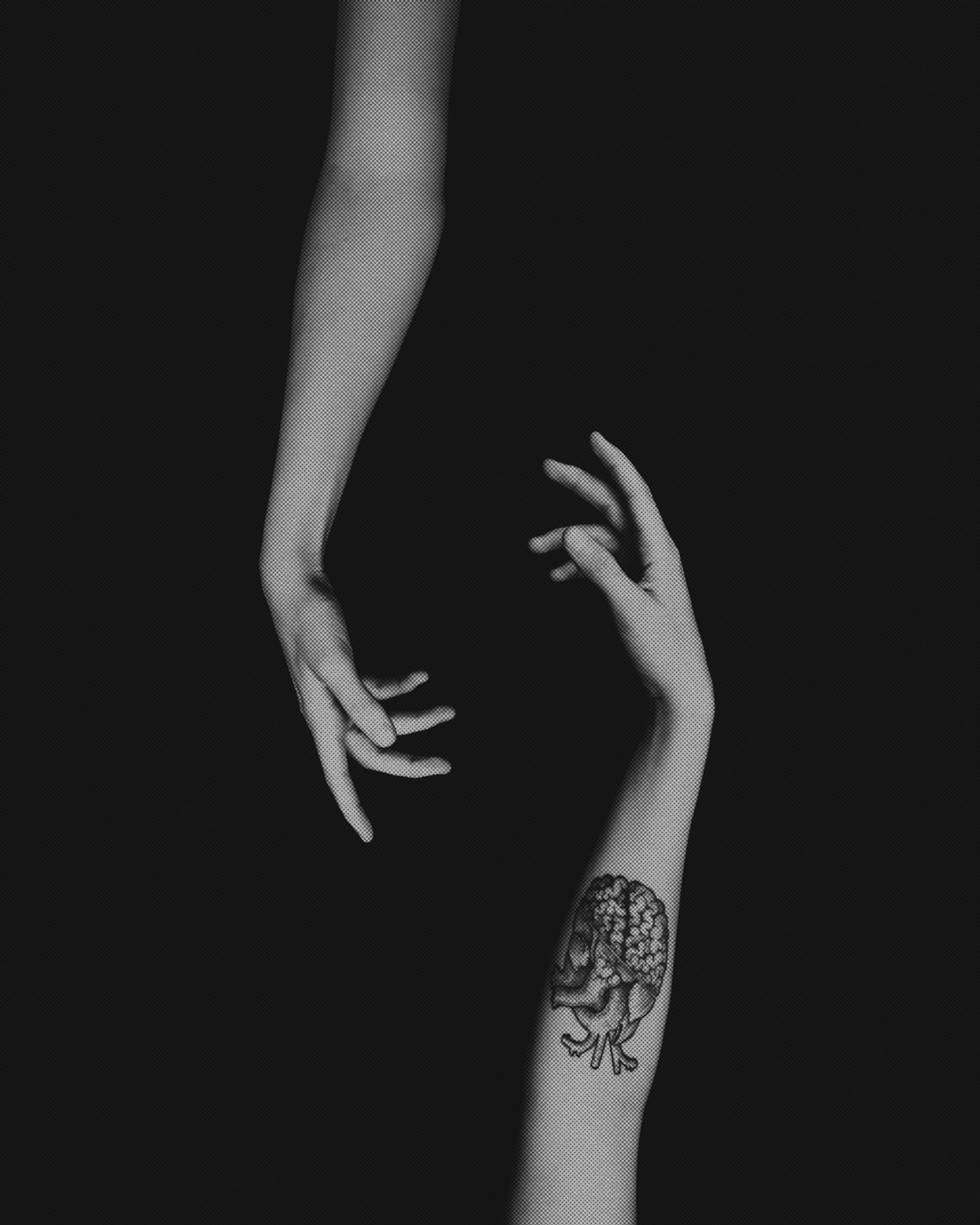 two women’s arms, one with a tattoo, reach for each other two women’s arms, one with a tattoo, reach for each other