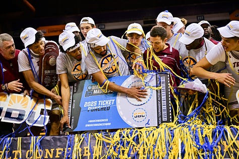 The Troy men's basketball team celebrates after a 94-81 victory over Arkansas State Monday night in the Sun Belt Conference Tournament in Pensacola. The Trojans will now wait for NCAA Selection Show to see where they end up in the NCAA Tournament.