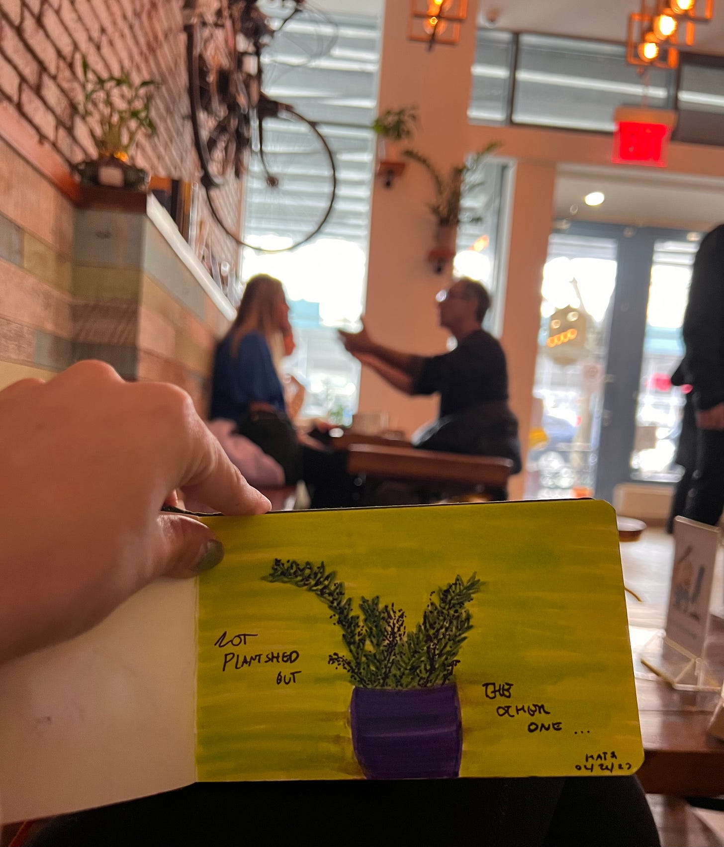 Katya is in a cafe and doodling a plant. 