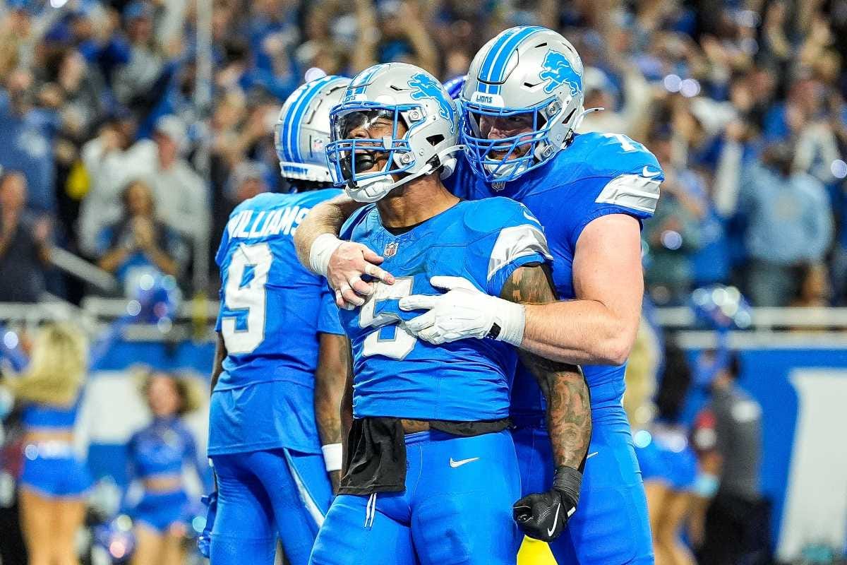 David Montgomery is hugged by Frank Ragnow.