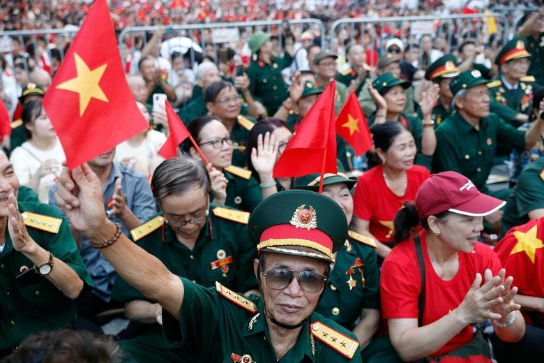 People wait to watch a parade marking Vietnam’s 80th National Day anniversary, at a street in Hanoi, Vietnam Tuesday, Sept. 2, 2025. (Luong Thai Linh/Pool Photo via AP)