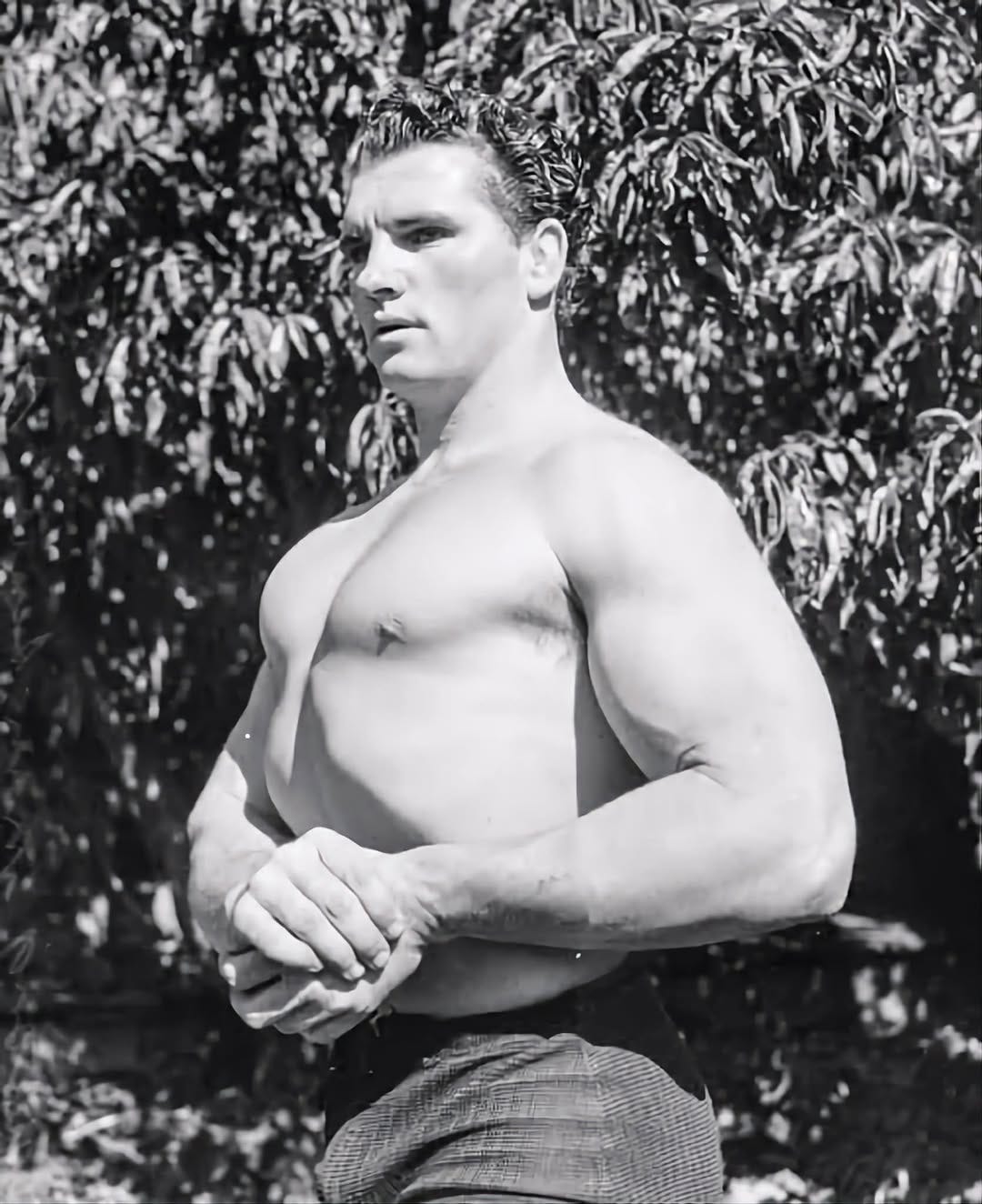 May be a black-and-white image of body building May be a black-and-white image of body building